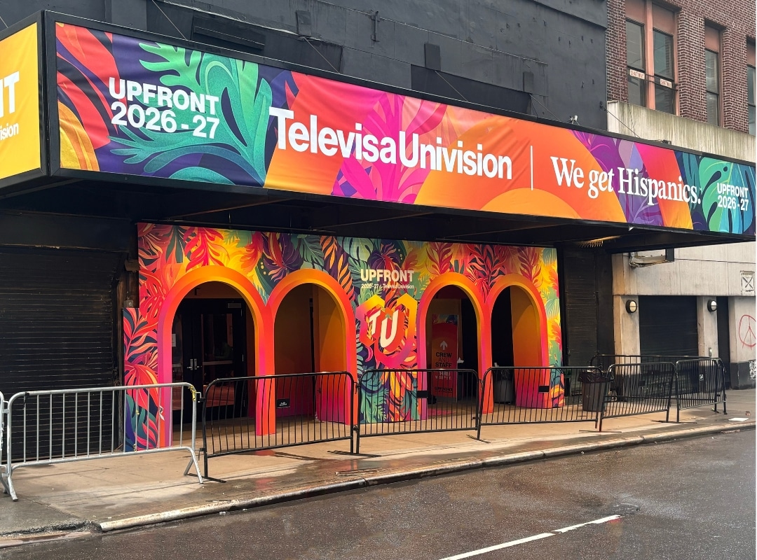 A colorful storefront with arched entryways displays "TelevisaUnivision" and "We get Hispanics" banners for the 2026-27 Upfront event.