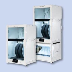 Two Ultimaker S5 3D printers are shown on a light blue background; one printer includes a lower storage unit with drawers for filament spools.