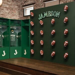 A display wall with a Jameson sign features mounted footballs, next to green lockers with jerseys and hats inside, set against a brick wall.
